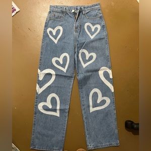 Never worn jeans with hearts on them, size medium